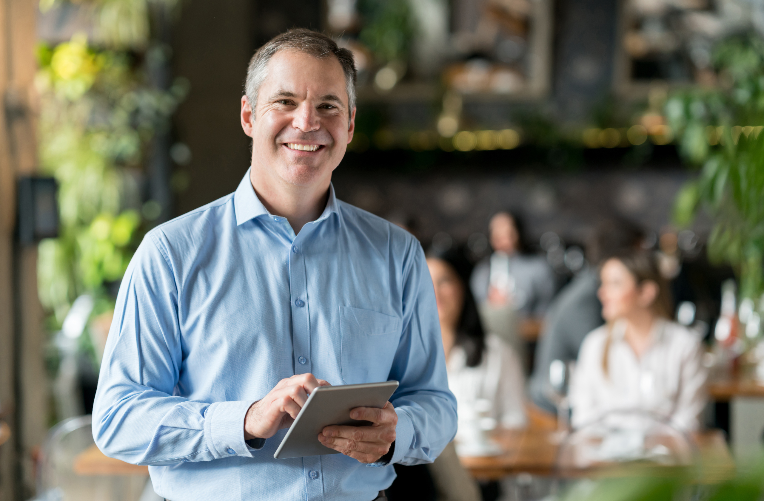 Small business owner using AI tools provided by HoopJumper to manage leads and grow online